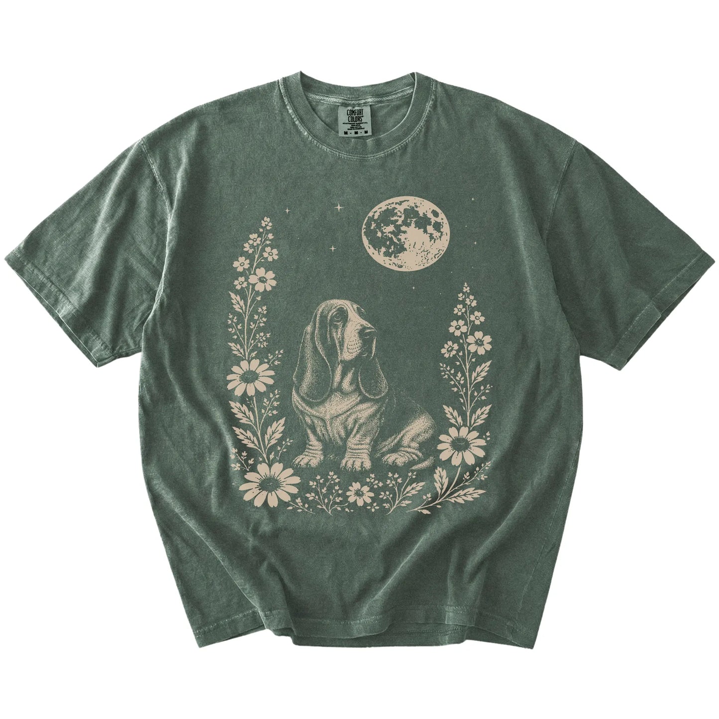 Basset Hound framed by flowers beneath the moon on a Moss Comfort Colors® T-shirt