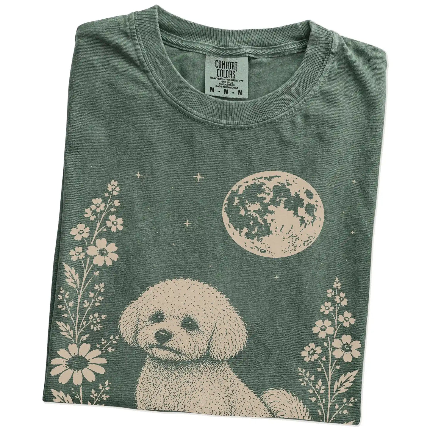 Folded Moss Comfort Colors® T-shirt showing Bichon Frise framed by flowers beneath the moon