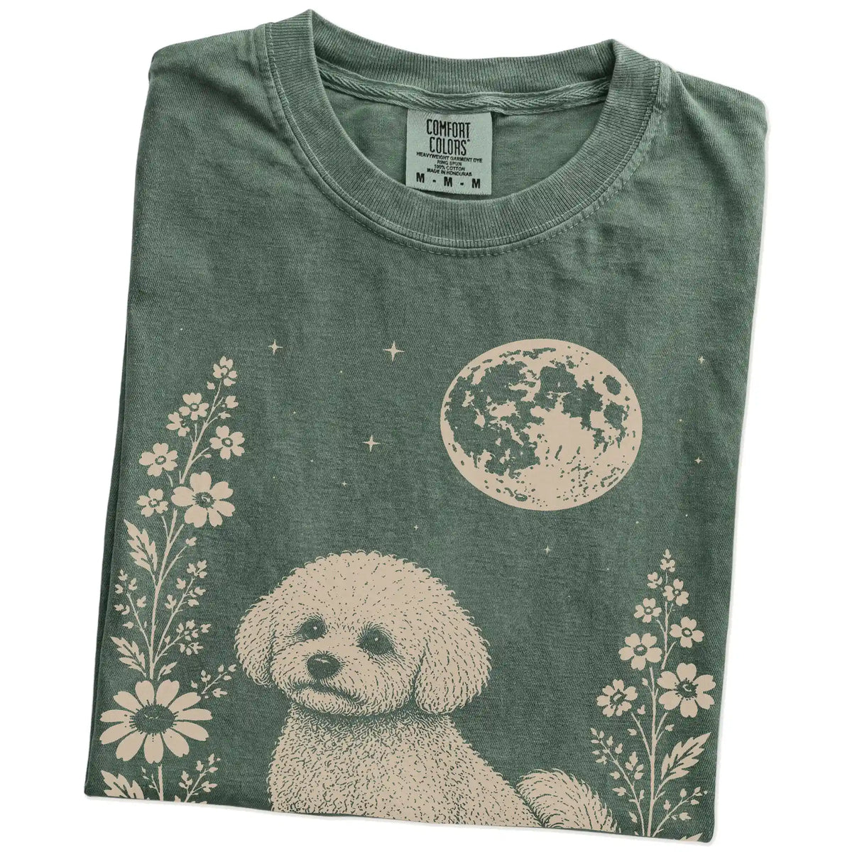 Folded Moss Comfort Colors® T-shirt showing Bichon Frise framed by flowers beneath the moon