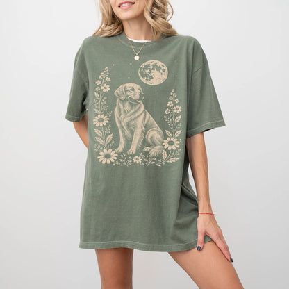 Model wearing a Moss Comfort Colors® T-shirt featuring Golden Retriever framed by flowers beneath the moon