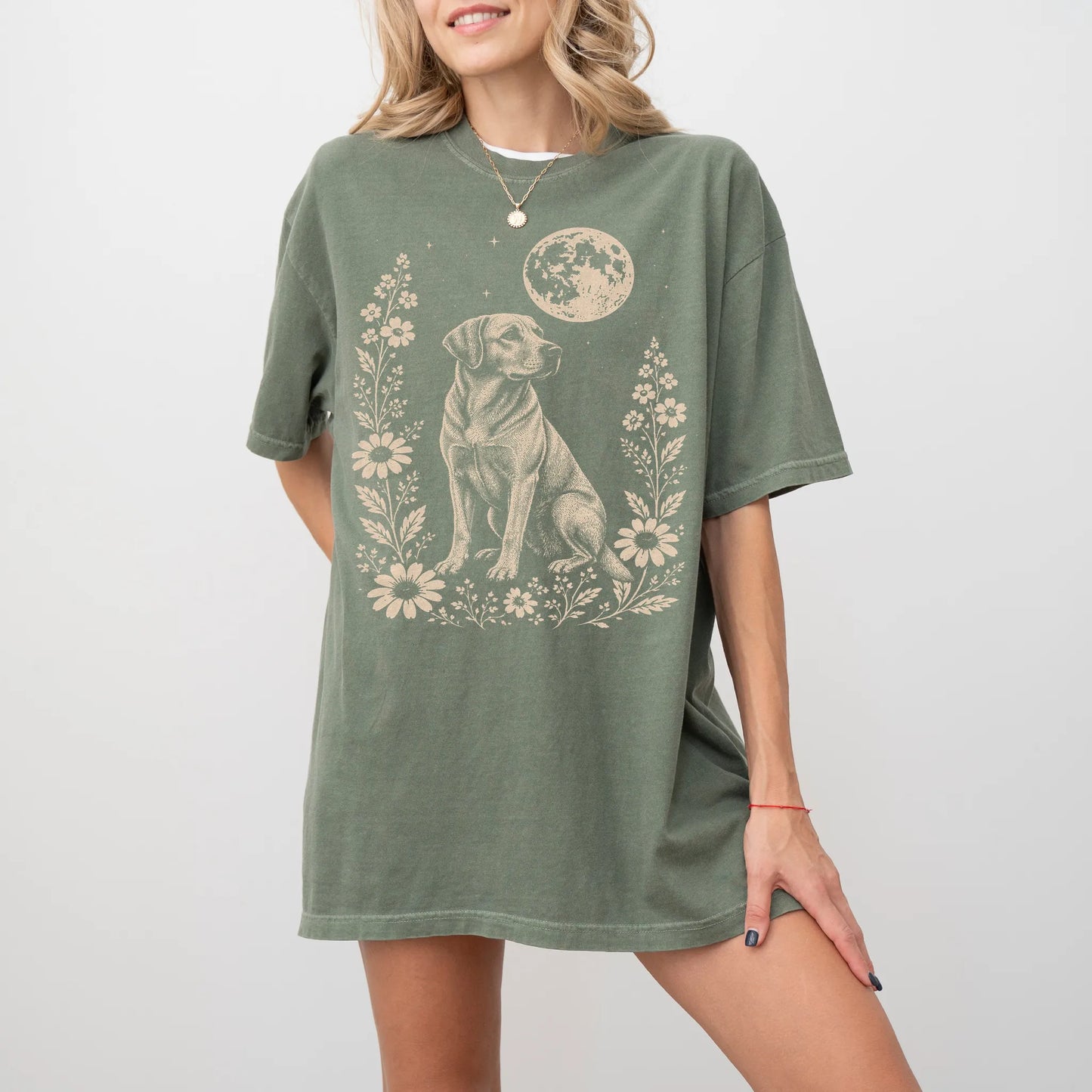 Model wearing a Moss Comfort Colors® T-shirt featuring Labrador Retriever framed by flowers beneath the moon