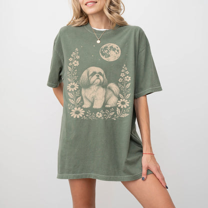 Model wearing a Moss Comfort Colors® T-shirt featuring Shih Tzu framed by flowers beneath the moon
