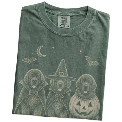 Folded Moss Comfort Colors® T-shirt showing three Newfie dogs dressed for Halloween beneath bats and a crescent moon