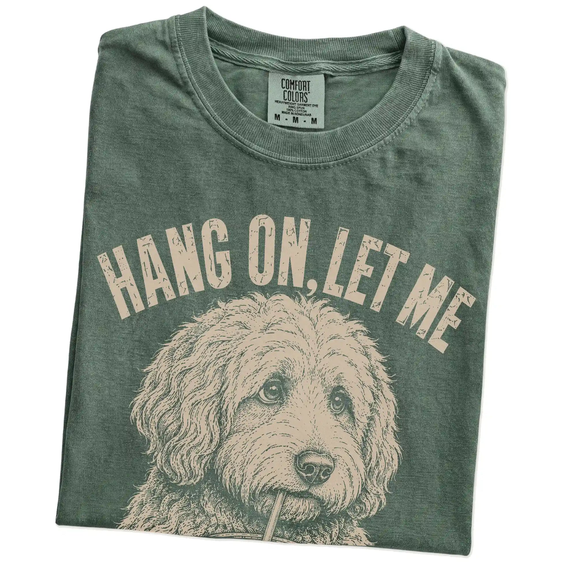 Folded Moss Overthinking Goldendoodle T-Shirt showing the graphic
