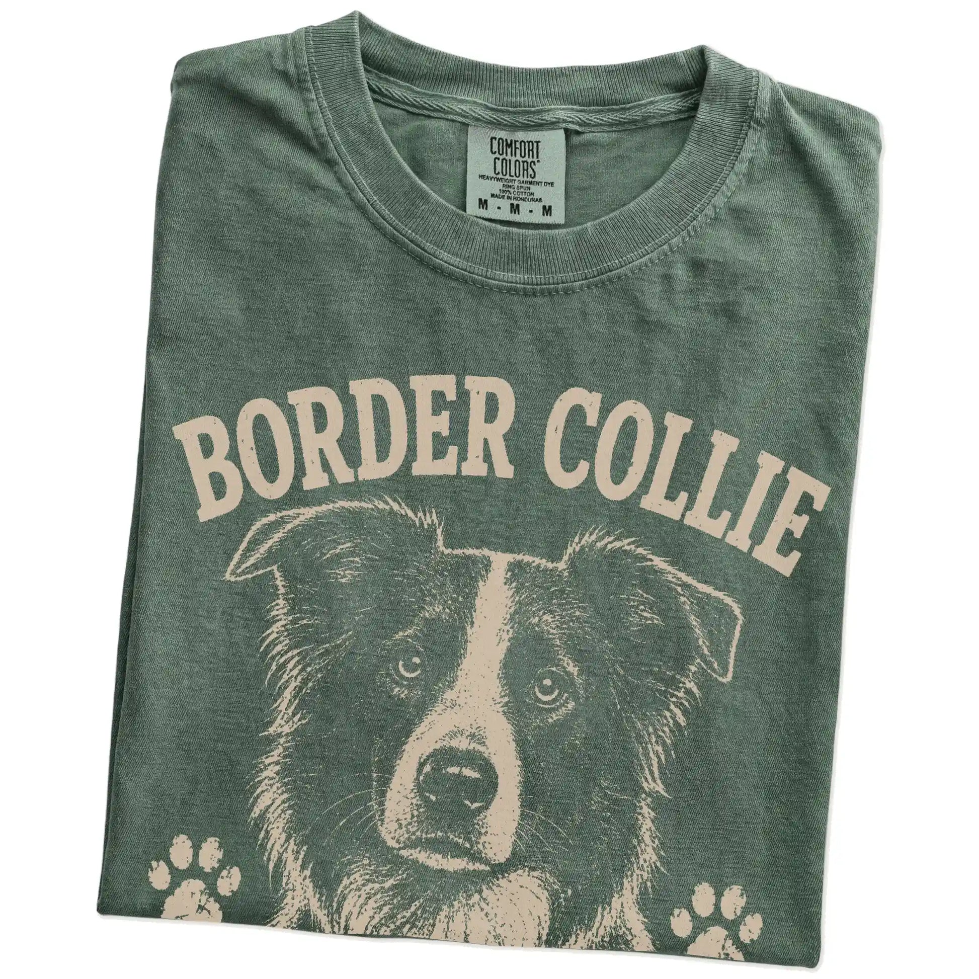 Folded Moss Comfort Colors® T-shirt showing Border Collie design with “Overthinking Is My Cardio” lettering