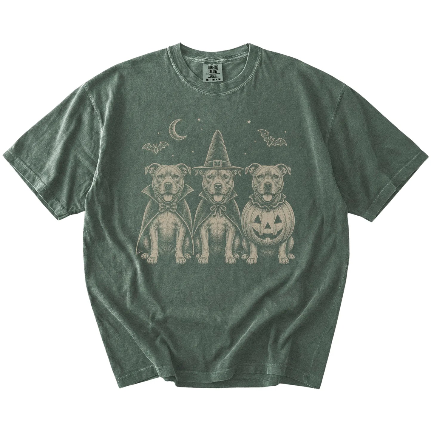 Three Pitbull dogs dressed for Halloween beneath bats and a crescent moon on a Moss Comfort Colors® T-shirt
