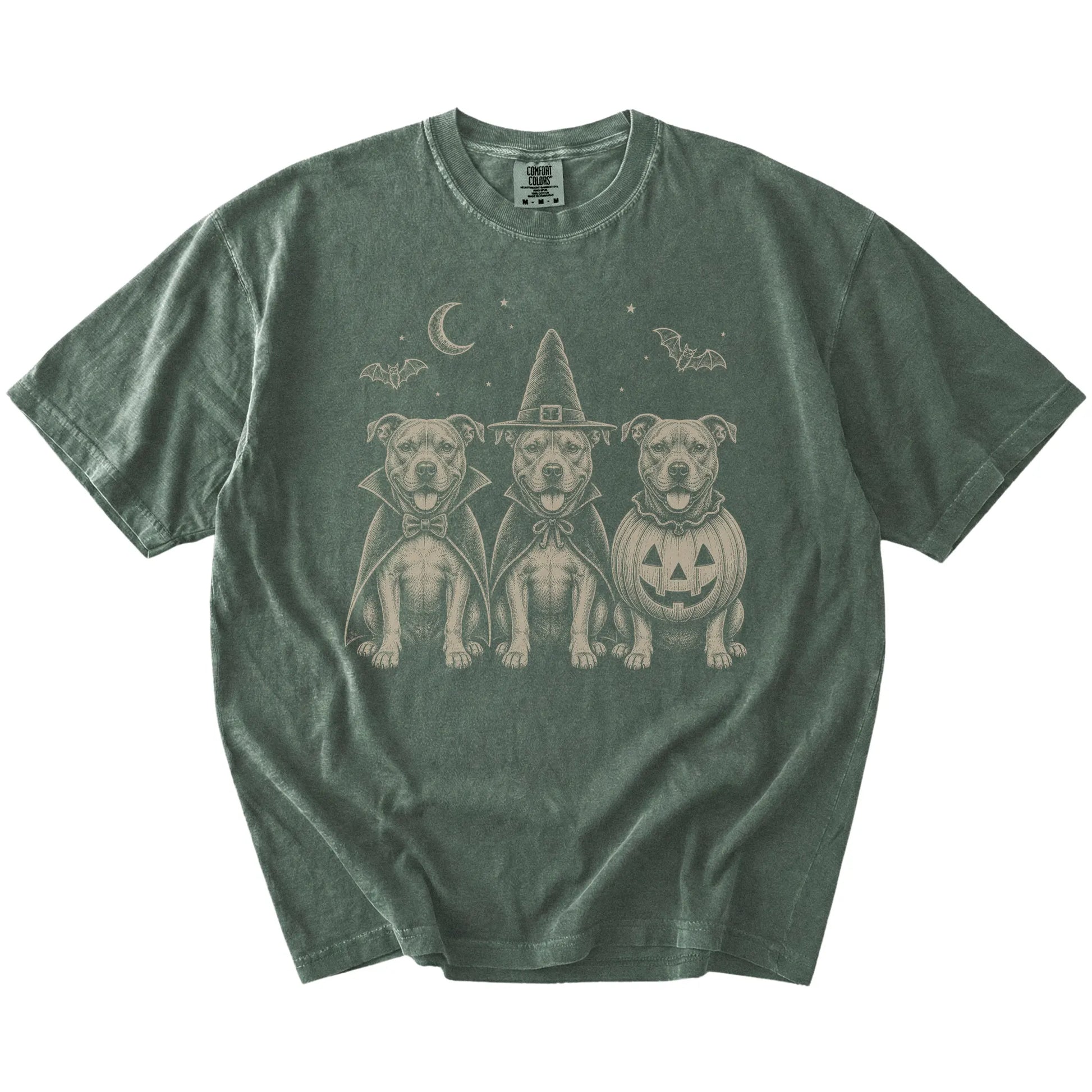 Three Pitbull dogs dressed for Halloween beneath bats and a crescent moon on a Moss Comfort Colors® T-shirt