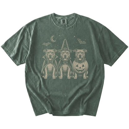 Three Pitbull dogs dressed for Halloween beneath bats and a crescent moon on a Moss Comfort Colors® T-shirt