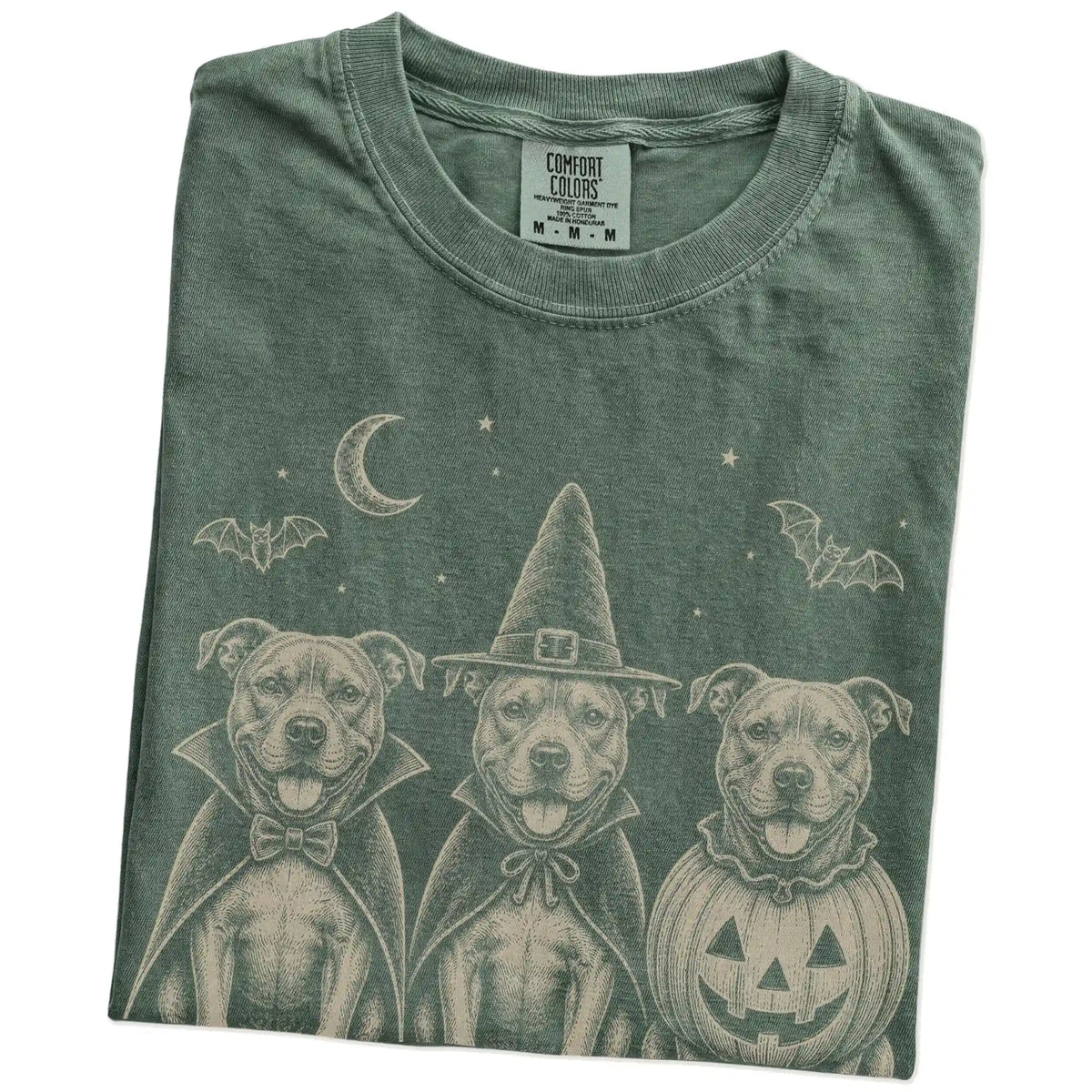 Folded Moss Comfort Colors® T-shirt showing three Pitbull dogs dressed for Halloween beneath bats and a crescent moon