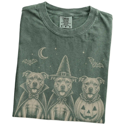 Folded Moss Comfort Colors® T-shirt showing three Pitbull dogs dressed for Halloween beneath bats and a crescent moon