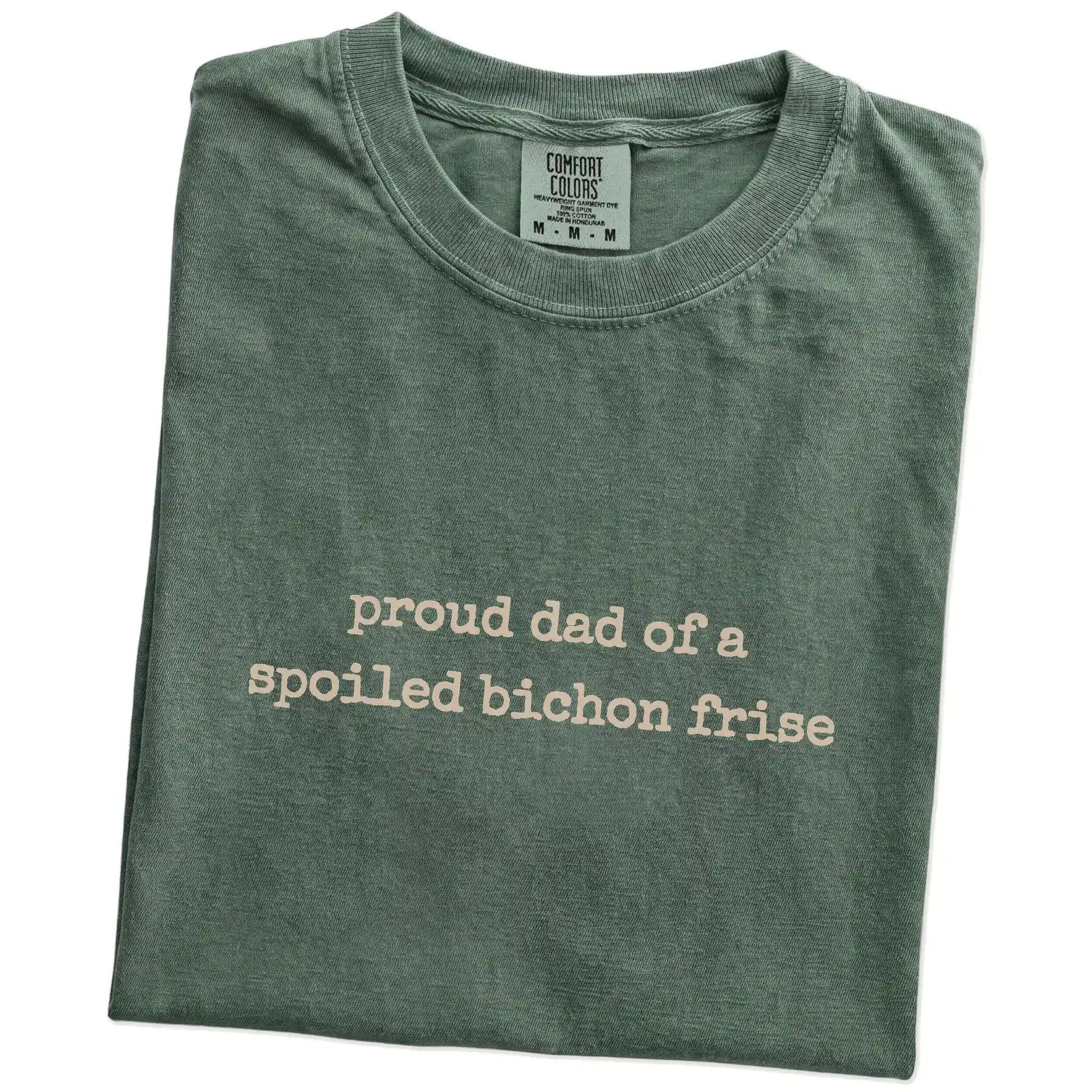 Folded Moss Comfort Colors® T-shirt showing proud dad of a spoiled bichon frise lettering