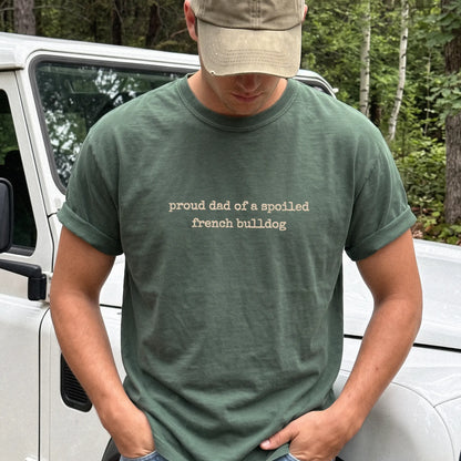 Model wearing a Moss Comfort Colors® T-shirt with proud dad of a spoiled french bulldog lettering
