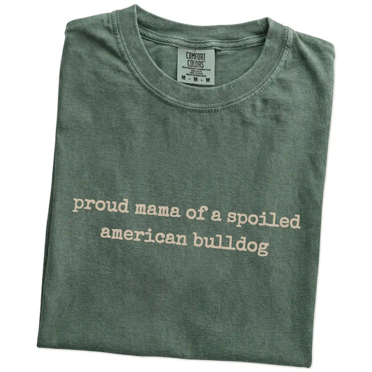 Folded Moss Comfort Colors® T-shirt showing Proud Mama of a Spoiled American Bulldog lettering