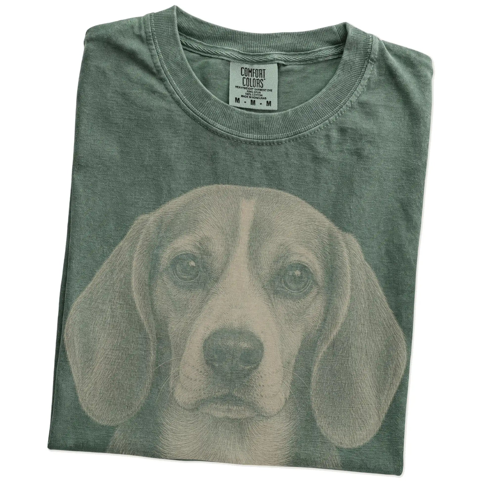 Folded Moss Comfort Colors® T-shirt showing a realistic drawing of a Beagle