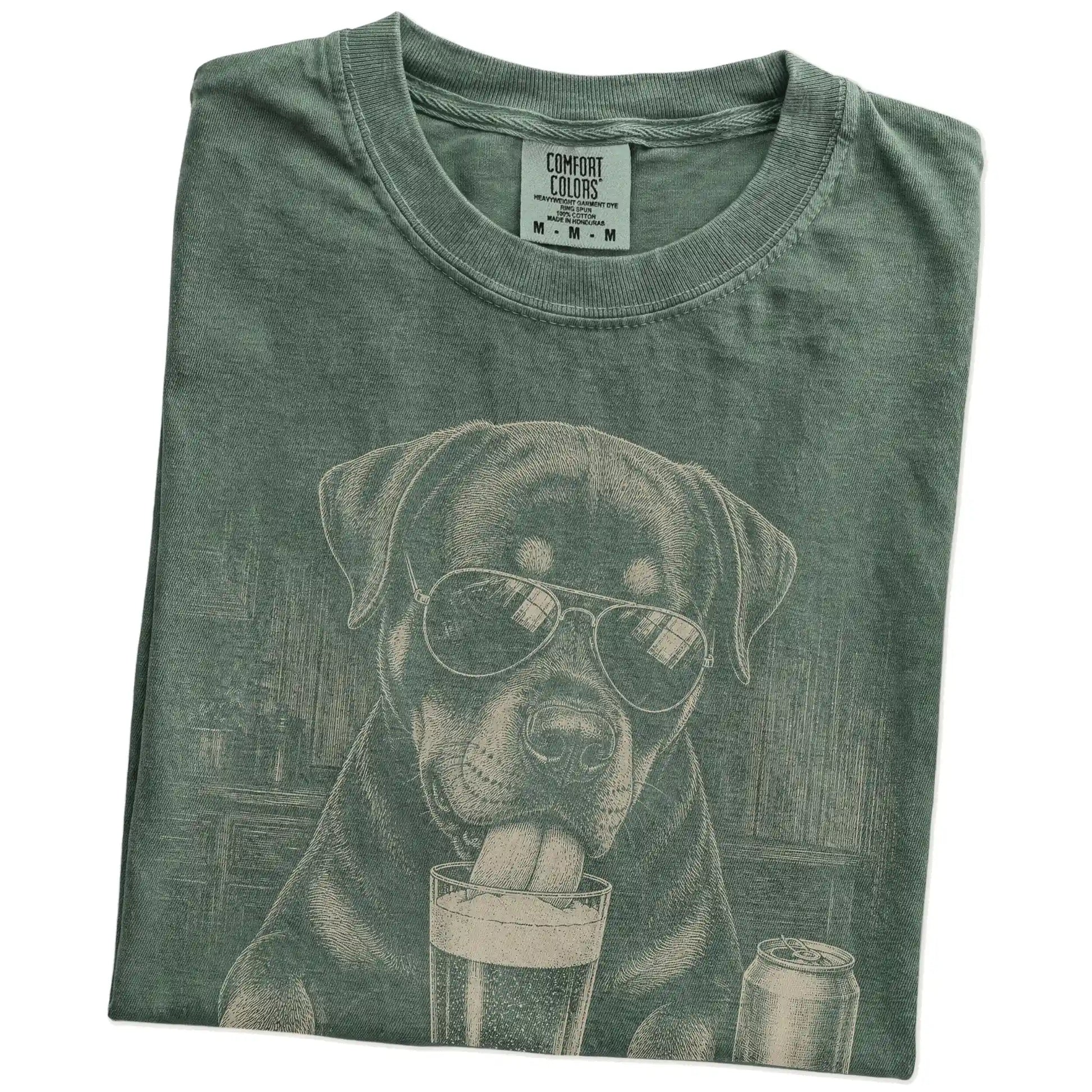 Folded Moss Comfort Colors® t-shirt showing Rottweiler sneaking a drink from a pint