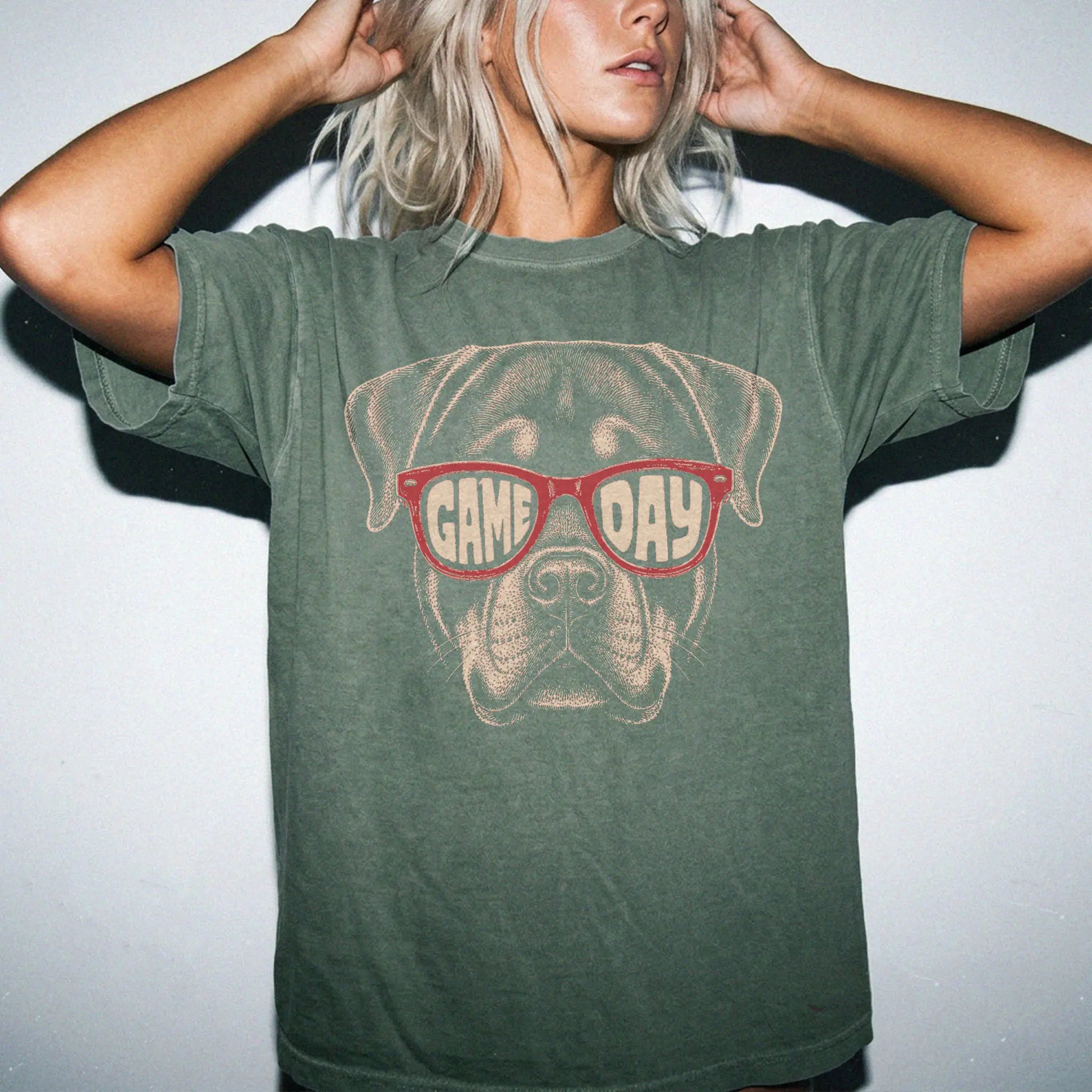 Model wearing a Moss Comfort Colors® T-shirt with rottweiler wearing red game day sunglasses