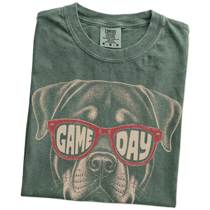 Folded Moss Comfort Colors® T-shirt showing rottweiler wearing red game day sunglasses