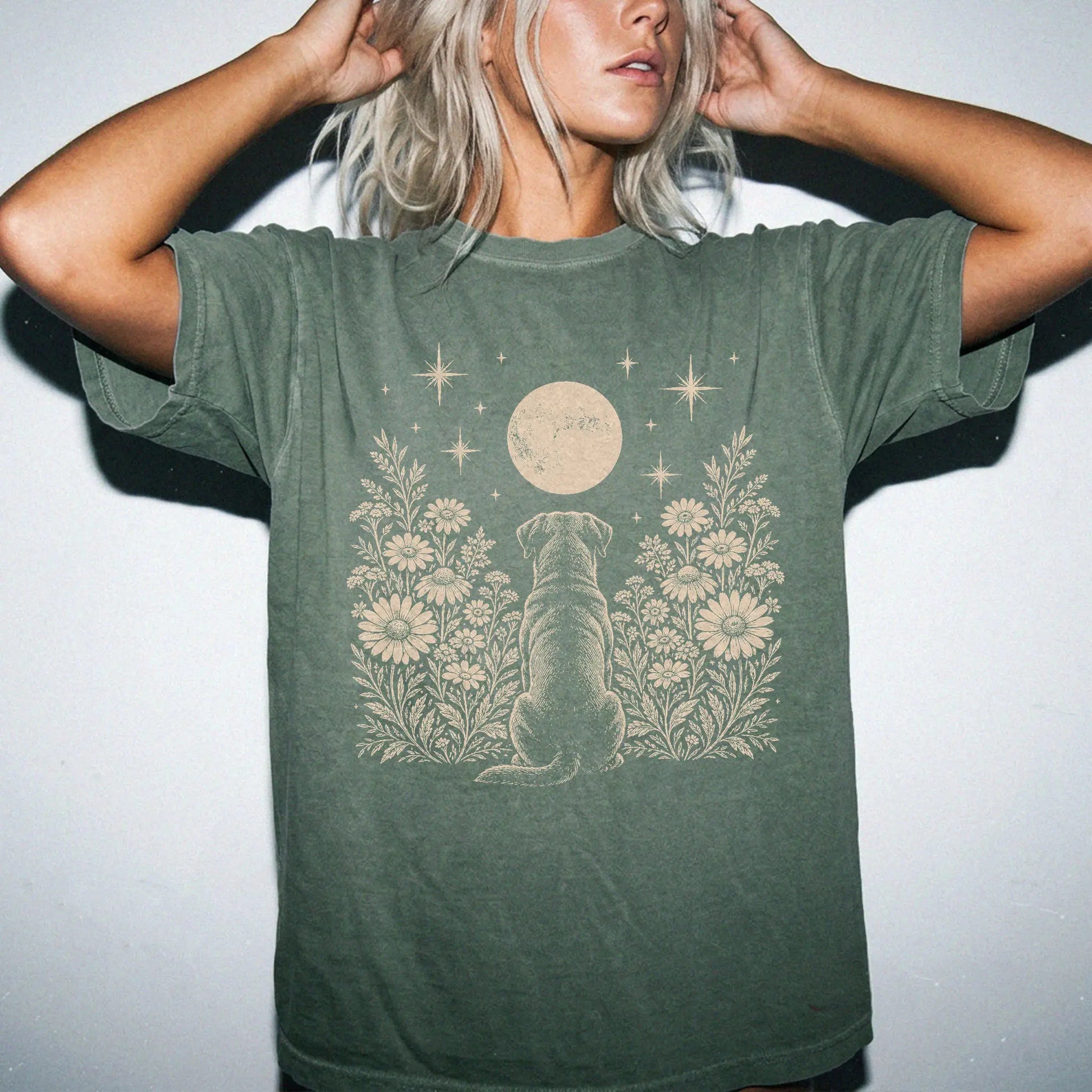 Model wearing a Moss Comfort Colors® T-shirt featuring Rottweiler beneath a wildflower moon