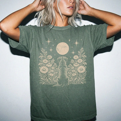 Model wearing a Moss Comfort Colors® T-shirt featuring Rottweiler beneath a wildflower moon