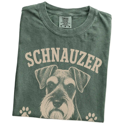 Folded Moss Comfort Colors® T-shirt showing Schnauzer design with “Serious Brows, Questionable Decisions” lettering