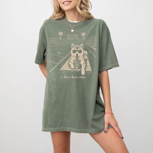 Model wearing a Moss Comfort Colors® T-shirt featuring Shiba Inu ready for football and tailgate season