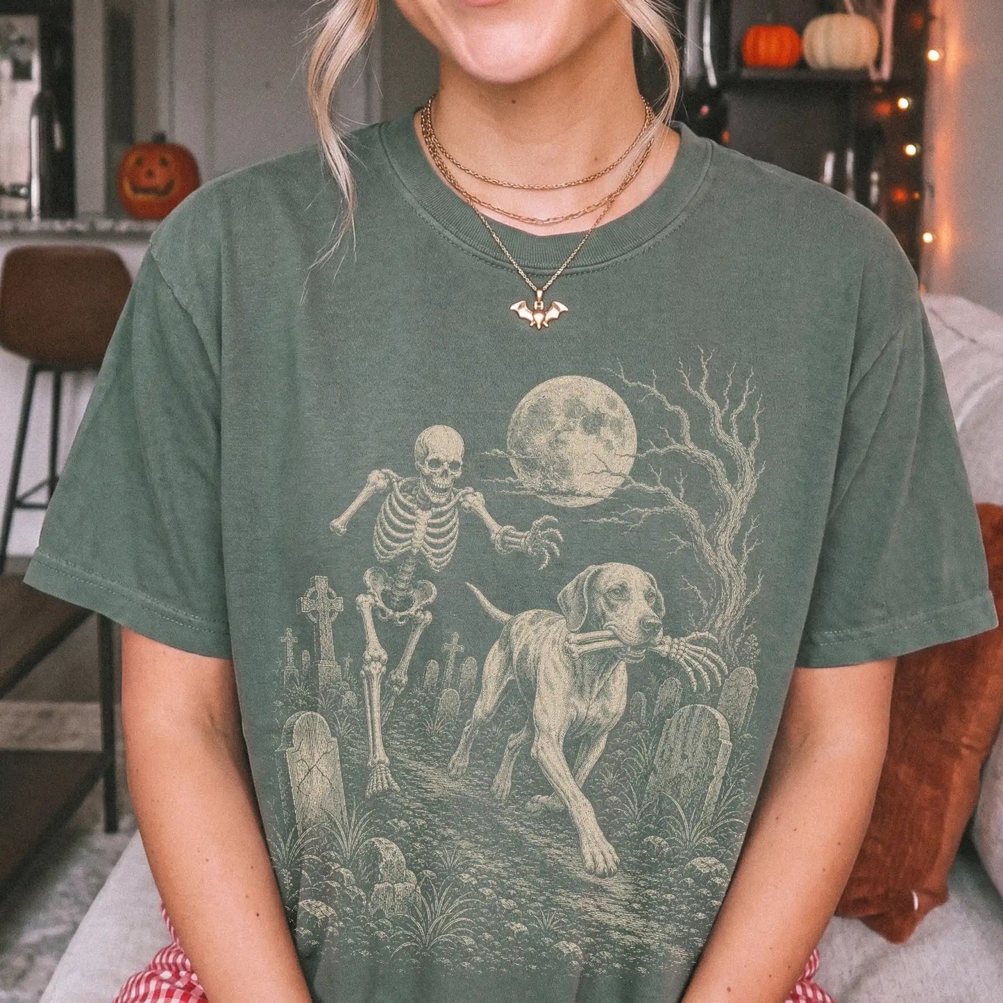 Model wearing a Moss Comfort Colors® T-shirt showing Pointer running through a moonlit graveyard with a chasing skeleton