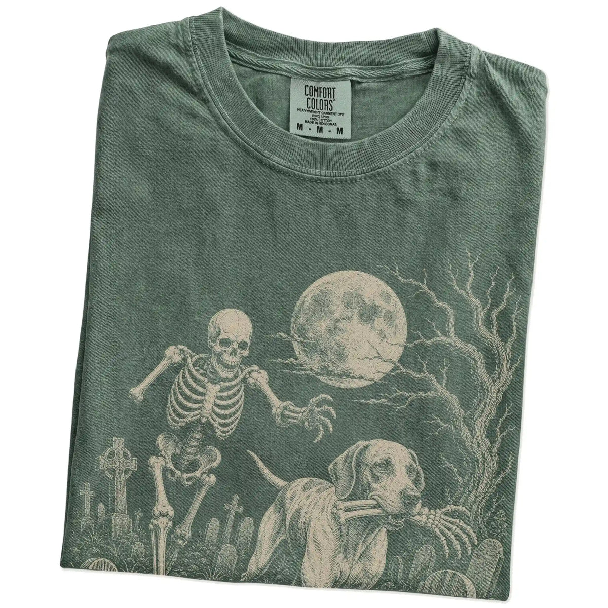 Folded Moss Comfort Colors® T-shirt showing Pointer running through a moonlit graveyard with a chasing skeleton