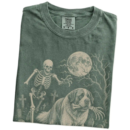 Folded Moss Comfort Colors® T-shirt showing Saint Bernard running through a moonlit graveyard with a chasing skeleton