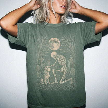 Model wearing a Moss Comfort Colors® T-shirt showing Beagle sharing a quiet cemetery moment with a friendly skeleton