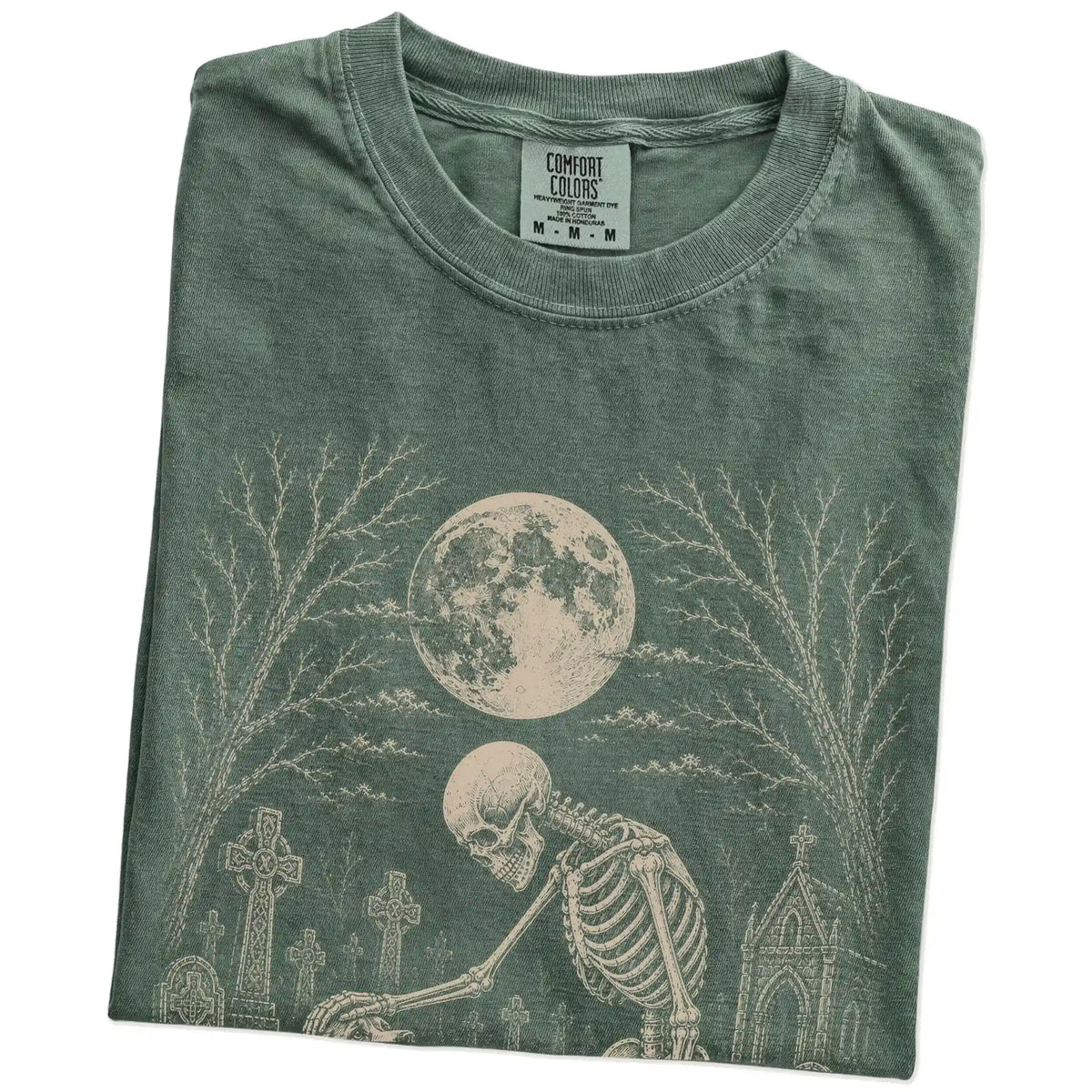 Folded Moss Comfort Colors® T-shirt showing Beagle sharing a quiet cemetery moment with a friendly skeleton