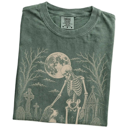 Folded Moss Comfort Colors® T-shirt showing Bernese Mountain Dog sharing a quiet cemetery moment with a friendly skeleton