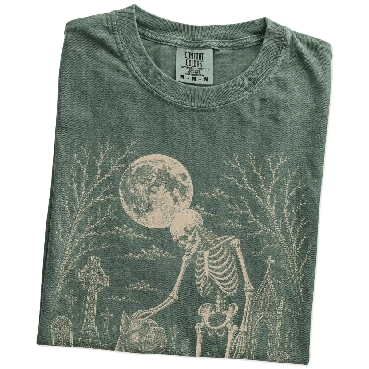 Folded Moss Comfort Colors® T-shirt showing Cane Corso sharing a quiet cemetery moment with a friendly skeleton