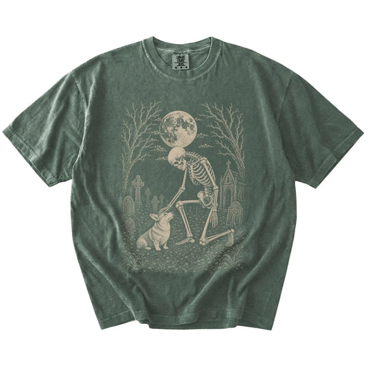 Corgi sharing a quiet cemetery moment with a friendly skeleton on a Moss Comfort Colors® T-shirt
