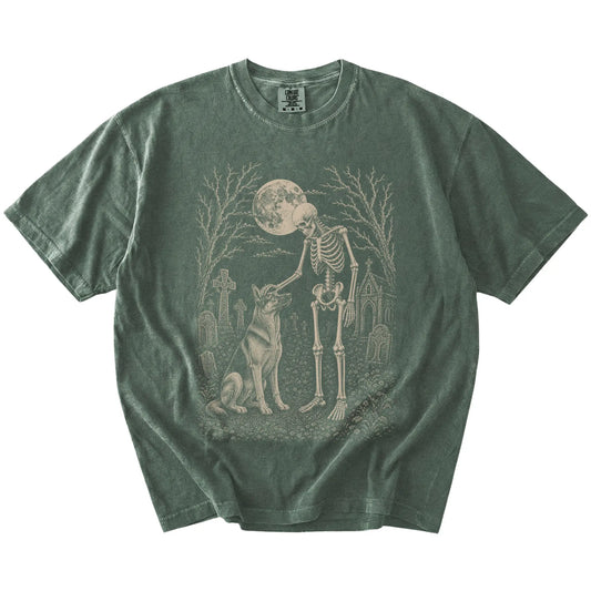 German Shepherd sharing a quiet cemetery moment with a friendly skeleton on a Moss Comfort Colors® T-shirt