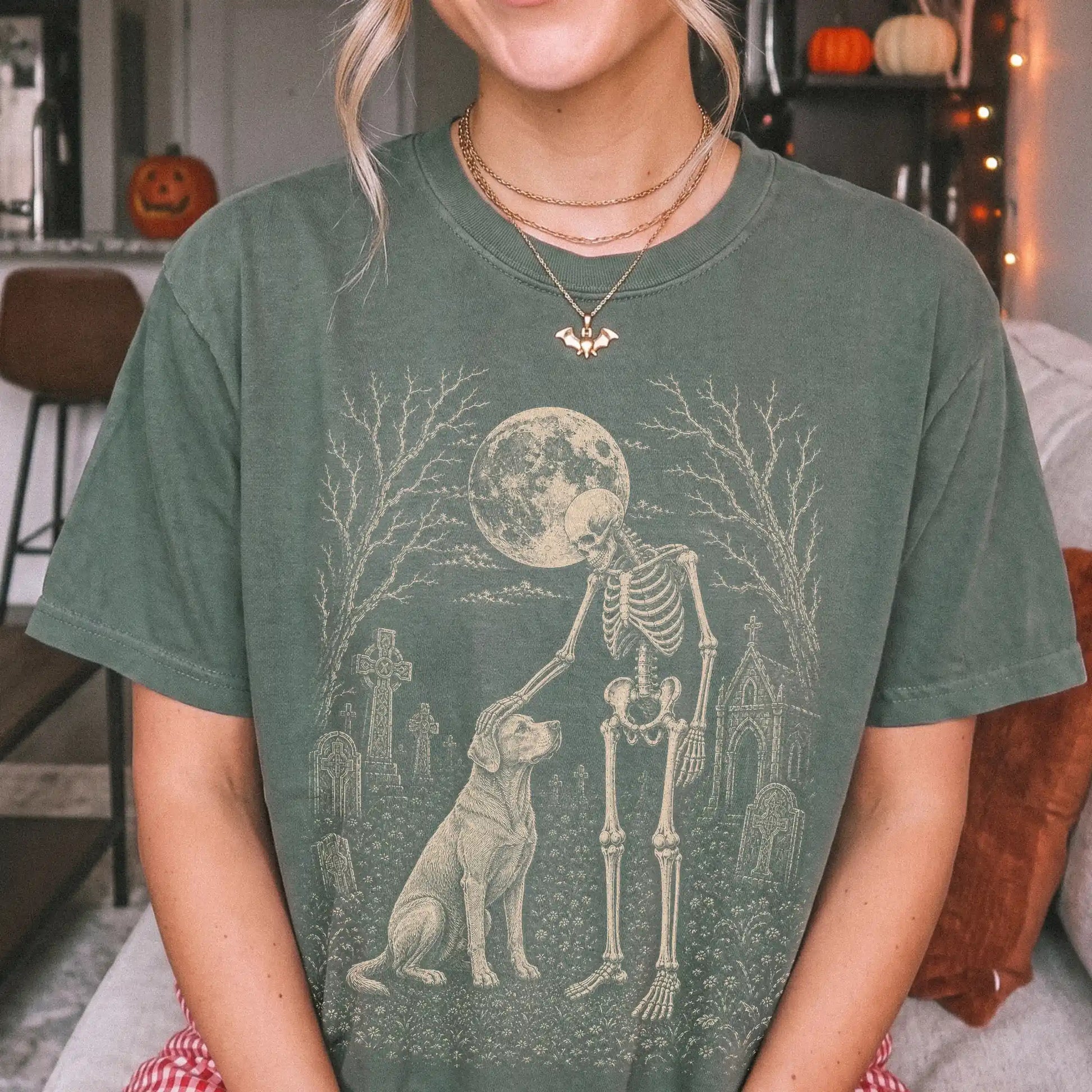 Model wearing a Moss Comfort Colors® T-shirt showing Labrador Retriever sharing a quiet cemetery moment with a friendly skele