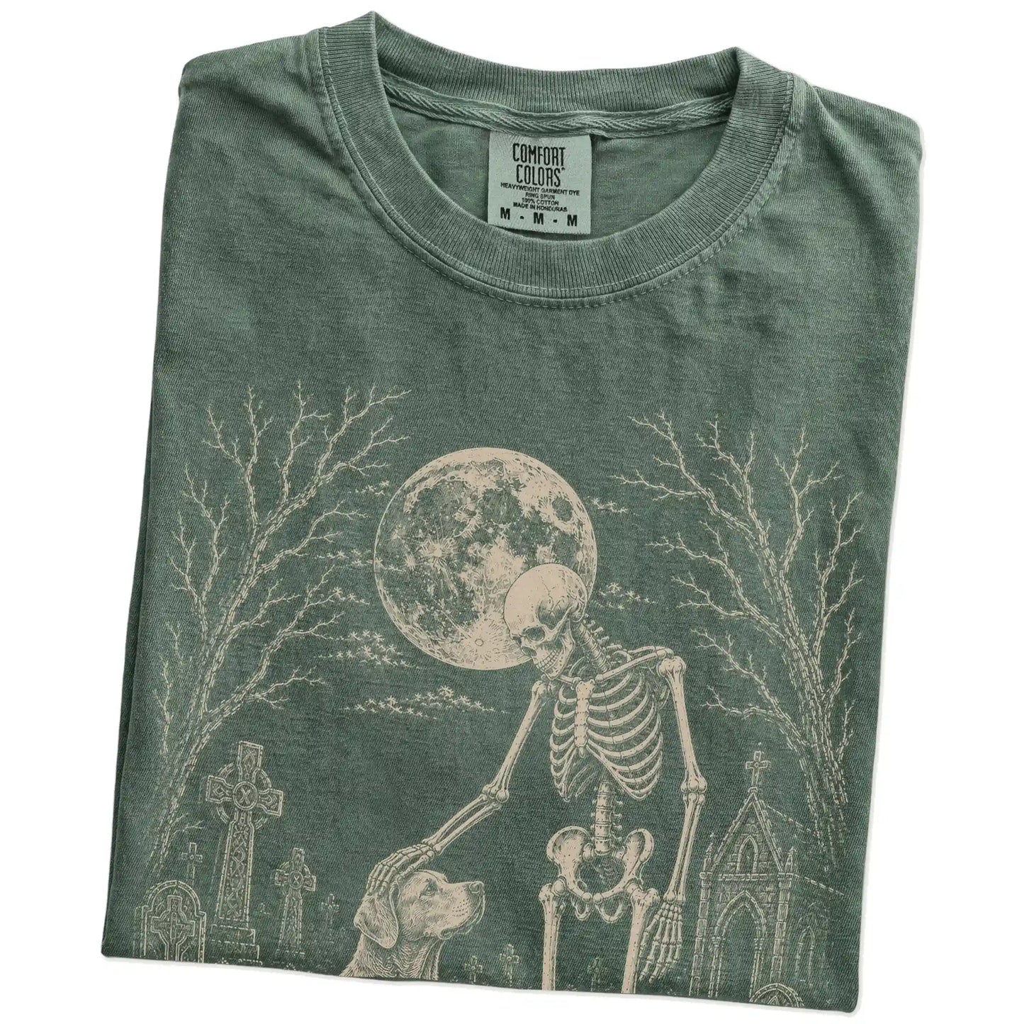 Folded Moss Comfort Colors® T-shirt showing Labrador Retriever sharing a quiet cemetery moment with a friendly skeleton