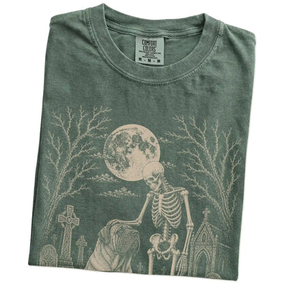 Folded Moss Comfort Colors® T-shirt showing Mastiff sharing a quiet cemetery moment with a friendly skeleton