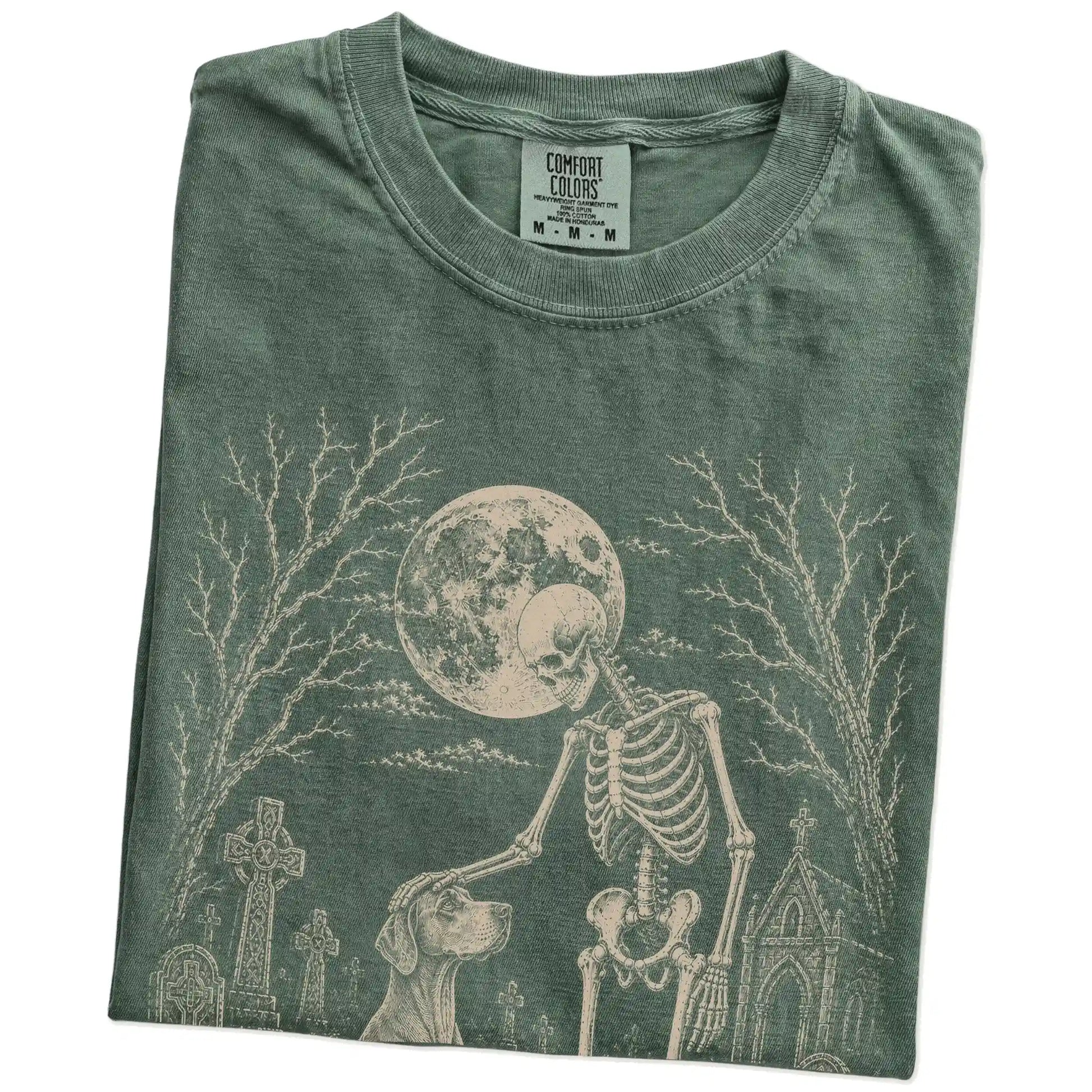 Folded Moss Comfort Colors® T-shirt showing Vizsla sharing a quiet cemetery moment with a friendly skeleton