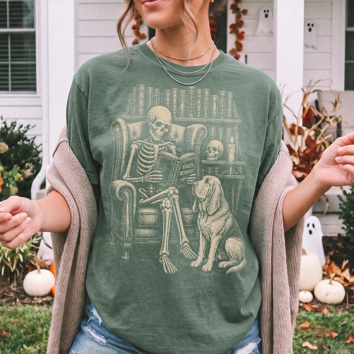Model wearing a Moss Comfort Colors® T-shirt showing skeleton reading in a library beside a Bloodhound