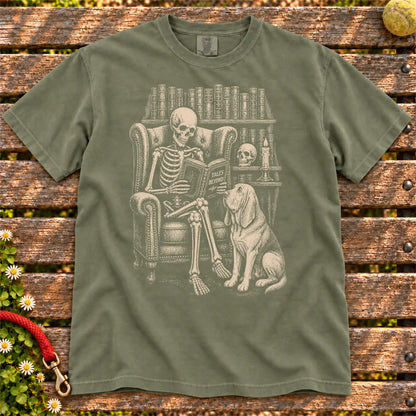 Skeleton reading in a library beside a Bloodhound on a Moss Comfort Colors® T-shirt