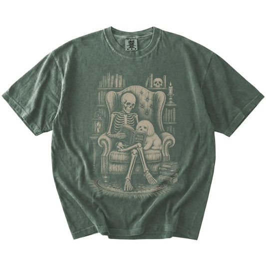 Skeleton reading in a library beside a Maltese on a Moss Comfort Colors® T-shirt