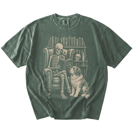 Skeleton reading in a library beside a Saint Bernard on a Moss Comfort Colors® T-shirt
