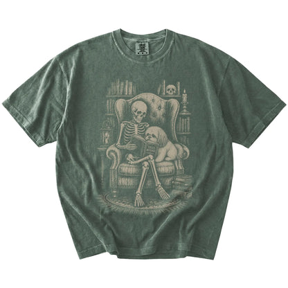 Skeleton reading in a library beside a Shih Tzu on a Moss Comfort Colors® T-shirt