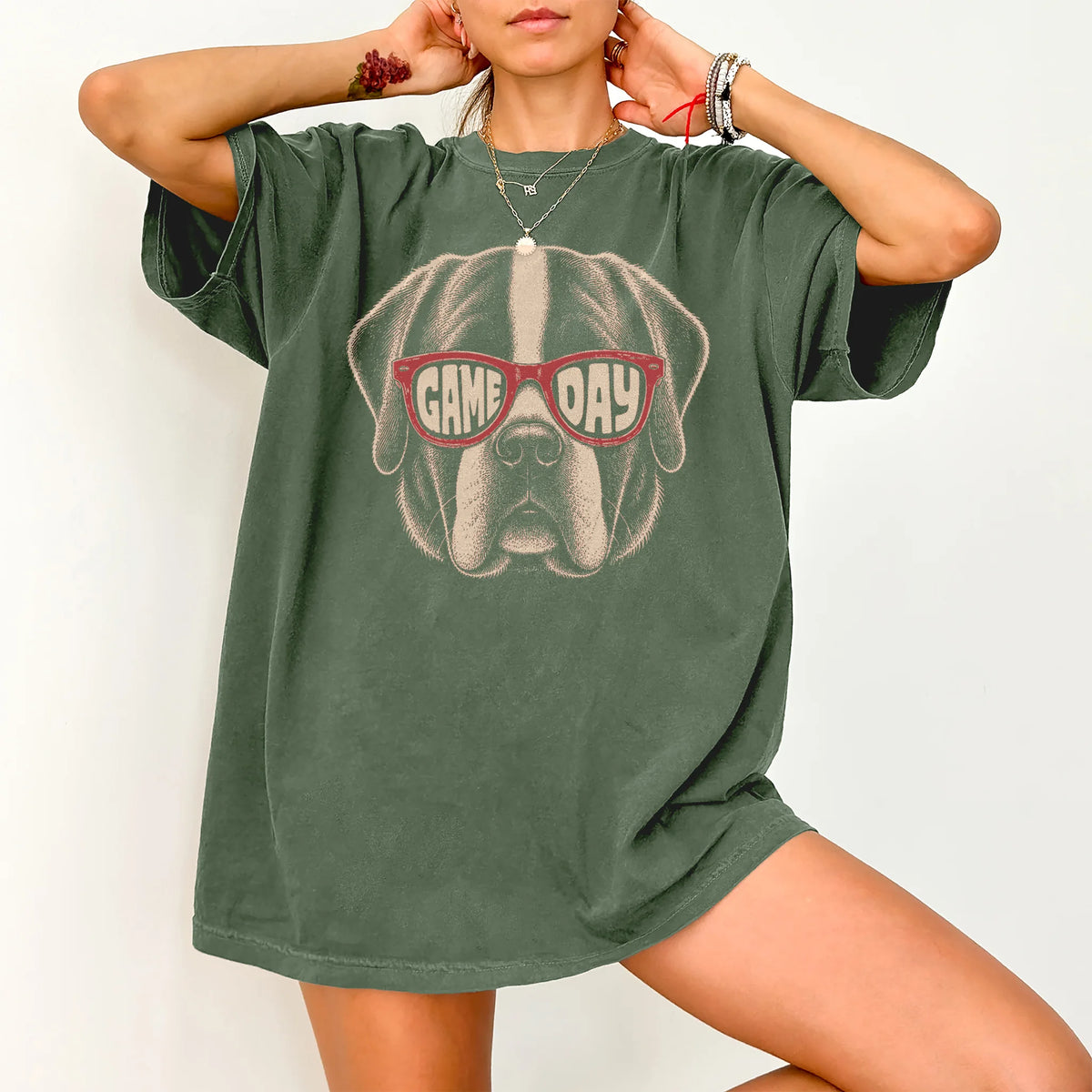 Model wearing a Moss Comfort Colors® T-shirt with saint bernard wearing red game day sunglasses
