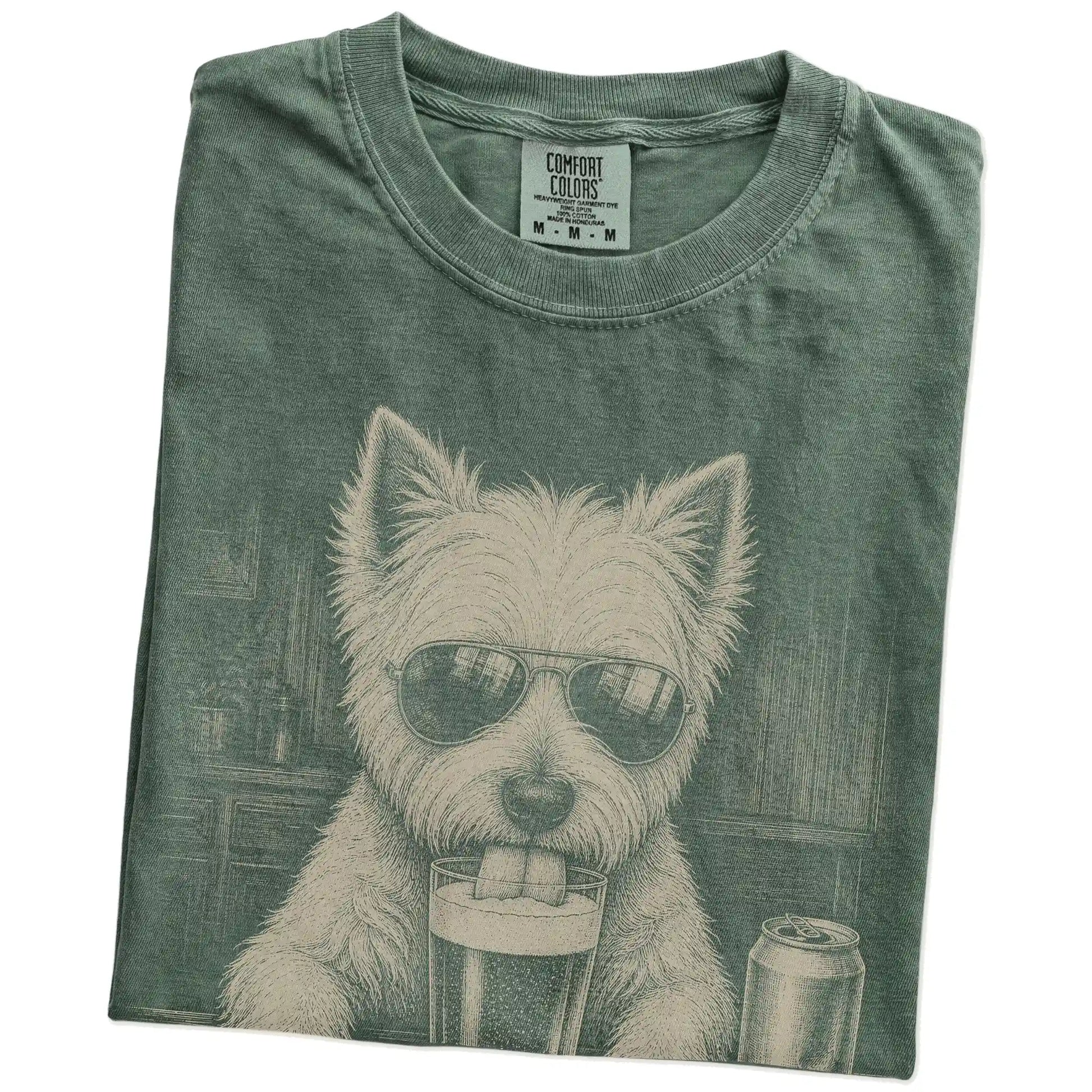 Folded Moss Comfort Colors® t-shirt showing Westie sneaking a drink from a pint