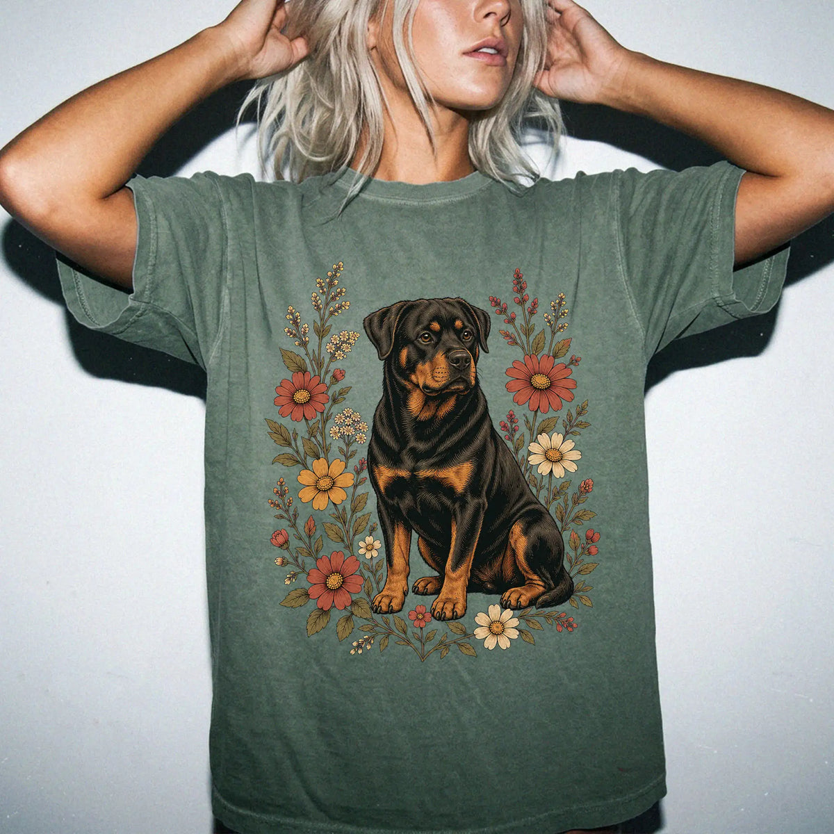 Model wearing a Moss Comfort Colors® T-shirt showing Rottweiler portrait surrounded by wildflowers beneath the moon