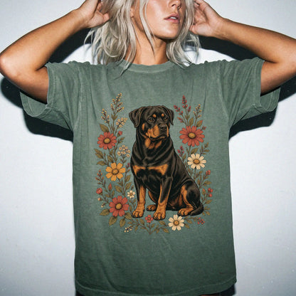Model wearing a Moss Comfort Colors® T-shirt showing Rottweiler portrait surrounded by wildflowers beneath the moon