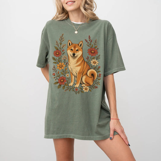 Model wearing a Moss Comfort Colors® T-shirt showing Shiba Inu portrait surrounded by wildflowers beneath the moon
