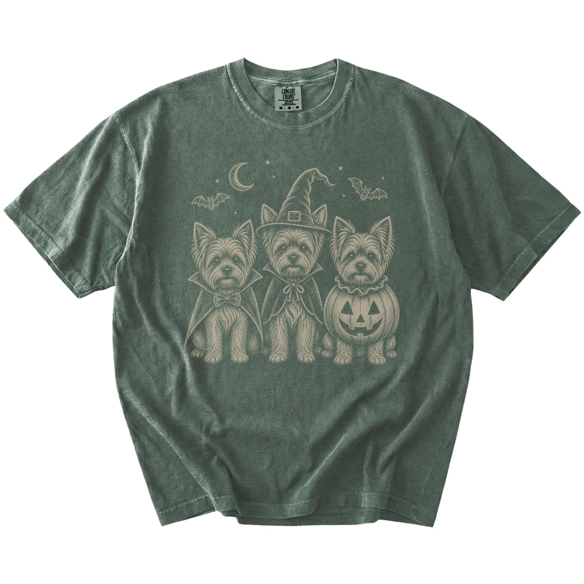 Three Yorkie dogs dressed for Halloween beneath bats and a crescent moon on a Moss Comfort Colors® T-shirt