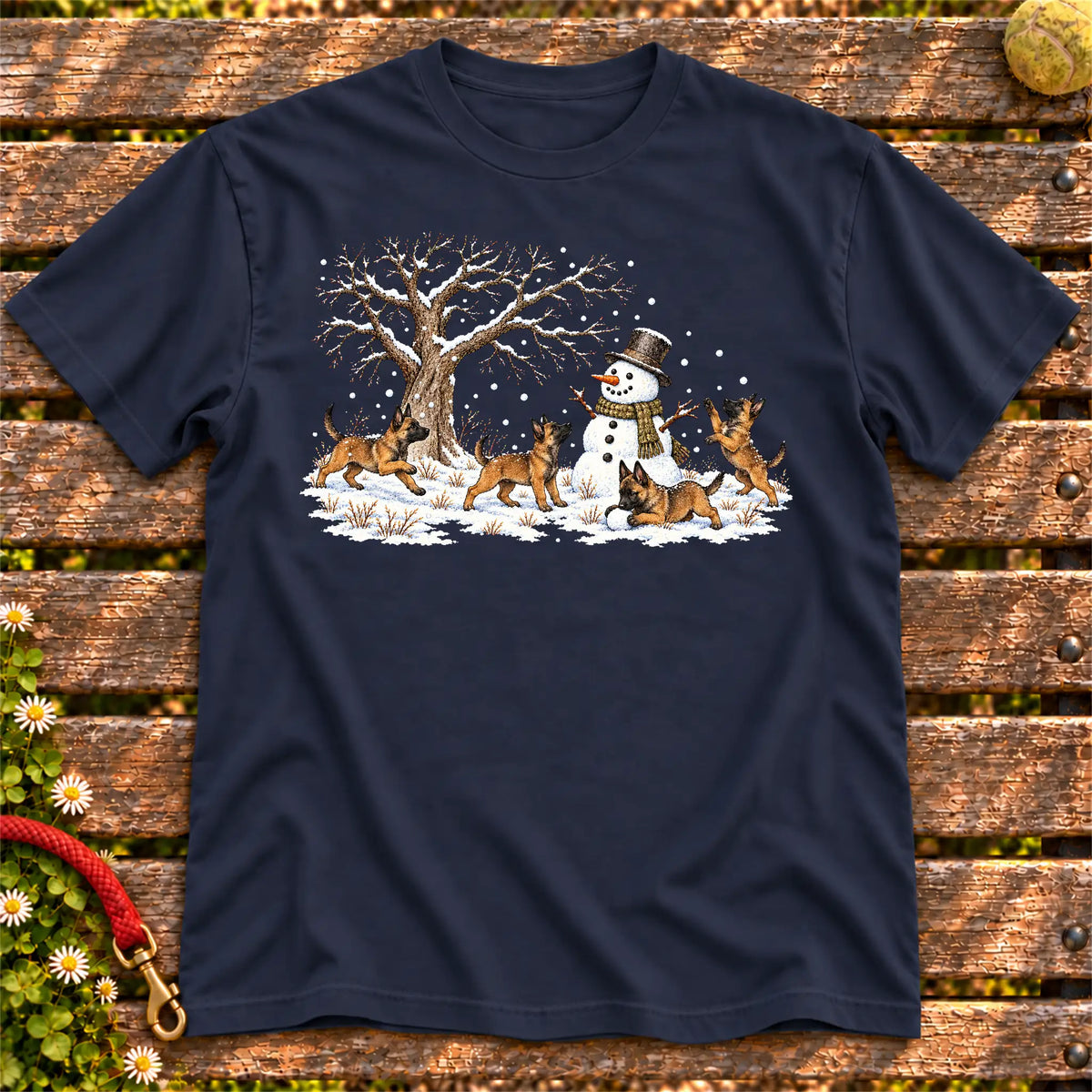 Belgian Malinois puppies playing in snow with a snowman on a Navy T-shirt